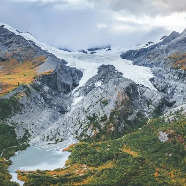 Scenic view of Svodufoss waterfall and Snaefellsjokull glacier in background, Iceland